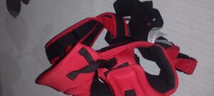 A black and red baby carrier